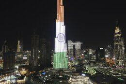 Dubai celebrates the new year in India by reflecting their national flag on the Burj Khalifa, the world's tallest building, to mark New Year in Dubai, United Arab Emirates, Friday, Jan. 1, 2021. (AP Photo/Kamran Jebreili)