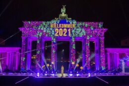 "Welcome 2021" is projected onto the Brandenburg Gate in Berlin on Thursday, Dec. 31, 2020. The New Year's Eve party at the historic landmark has been cancelled due to coronavirus pandemic. (Christoph Soeder/dpa via AP)