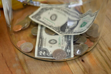 TAOS, NEW MEXICO - MAY 15, 2019: Money in a tip jar in a Taos, New Mexico, coffee shop includes a two dollar bill. (Photo by Robert Alexander/Getty Images)