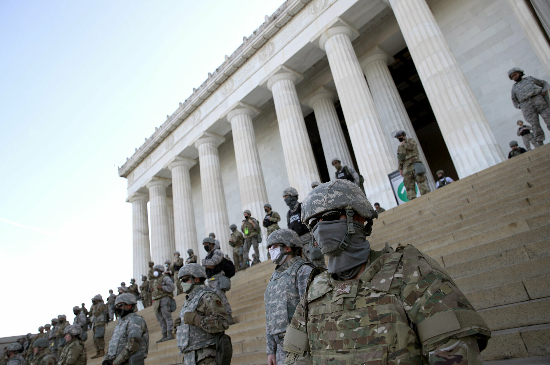 Masked members of the National Guard on the steps of the Lincoln Memorial.