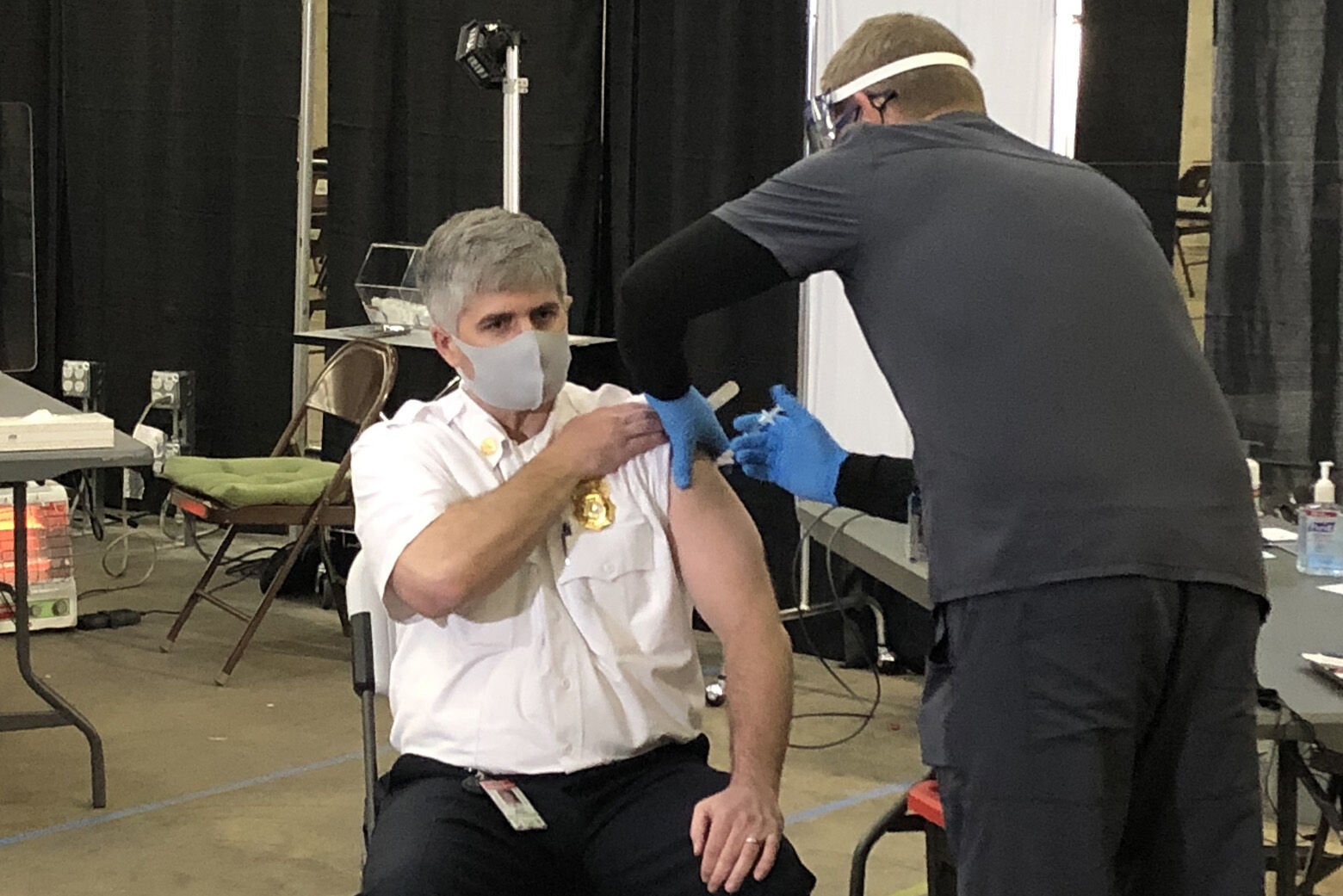 James Williams, assistant chief of operations for Loudoun County Fire and Rescue, receives the Moderna coronavirus vaccine Monday in Sterling.