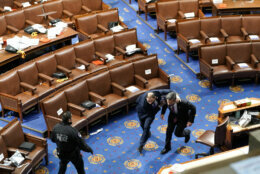 WASHINGTON, DC - JANUARY 06: Members of congress run for cover as protesters try to enter the House Chamber during a joint session of Congress on January 06, 2021 in Washington, DC. Congress held a joint session today to ratify President-elect Joe Biden's 306-232 Electoral College win over President Donald Trump. A group of Republican senators said they would reject the Electoral College votes of several states unless Congress appointed a commission to audit the election results. (Photo by Drew Angerer/Getty Images)