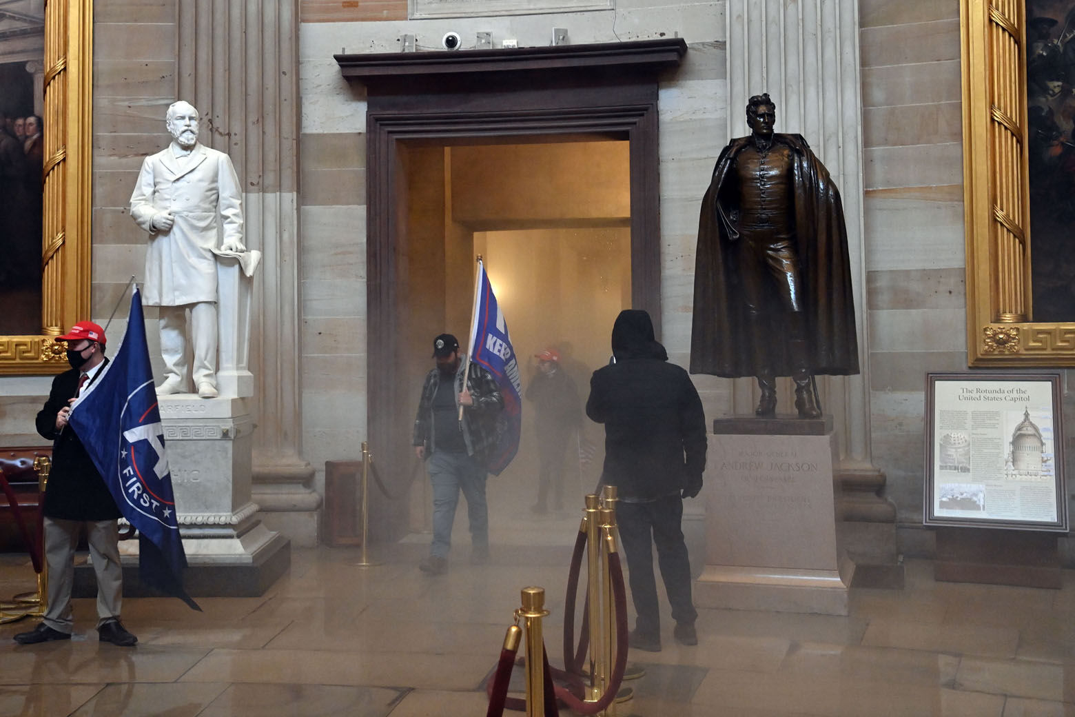 Supporters of US President Donald Trump enter the US Capitol's Rotunda as reported tear gas smoke fills a corridor on January 6, 2021, in Washington, DC. - Demonstrators breeched security and entered the Capitol as Congress debated the a 2020 presidential election Electoral Vote Certification. (Photo by Saul LOEB / AFP) (Photo by SAUL LOEB/AFP via Getty Images)