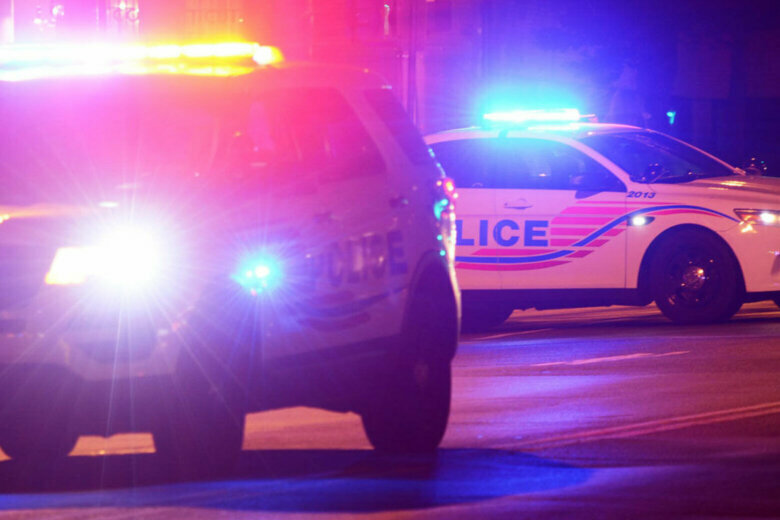 Two police cruisers with lights on.