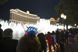 People celebrate New Year's Eve along the Las Vegas Strip Thursday, Dec. 31, 2020, in Las Vegas. (AP Photo/David Becker)