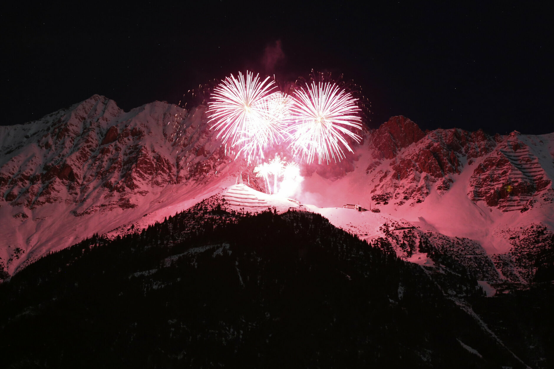 Fireworks light the sky during the New Year celebrations over the alps mountains massif 'Nordkette' in Innsbruck, Austria, Friday, Jan. 1, 2021. (AP Photo/Matthias Schrader)