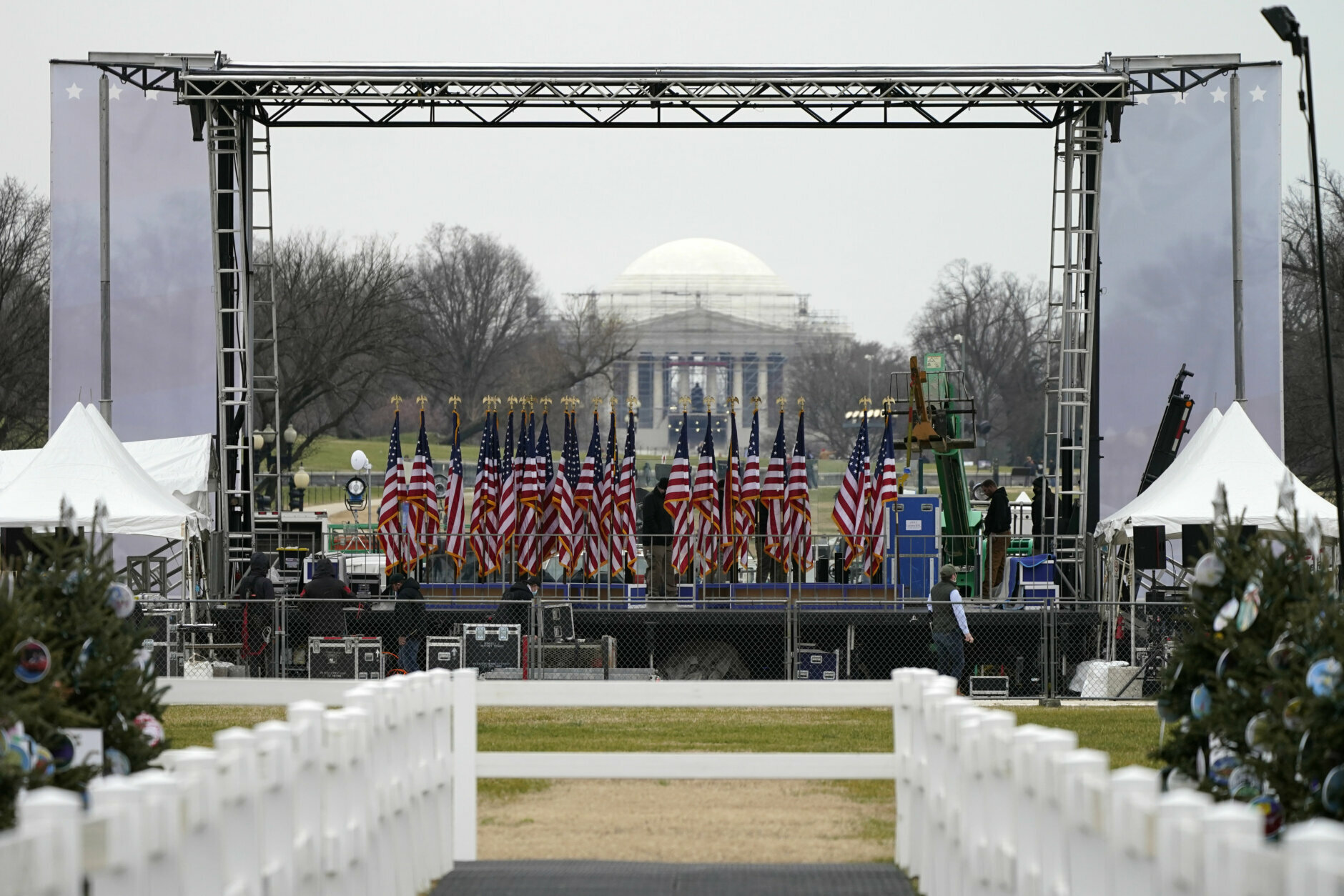 Workers build the stage on the ellipse near the White House on Tuesday, Jan. 5, 2021, ahead of expected rallies on Jan. 6 in support of President Donald Trump. The Thomas Jefferson Memorial can be seen in the background. (AP Photo/Jacquelyn Martin)