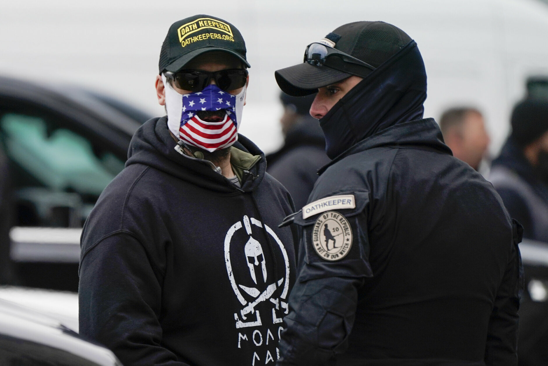 People wearing hats and patches indicating they are part of Oath Keepers attend a rally at Freedom Plaza Tuesday, Jan. 5, 2021, in Washington, in support of President Donald Trump. (AP Photo/Jacquelyn Martin)