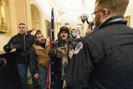 Supporters of President Donald Trump are confronted by U.S. Capitol Police officers outside the Senate Chamber inside the Capitol, Wednesday, Jan. 6, 2021 in Washington. (AP Photo/Manuel Balce Ceneta)