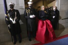 <p>Lady Gaga, flanked by Marine escort Capt. Evan Campbell, arrives to sing the National Anthem for the 59th Presidential Inauguration at the U.S. Capitol for President-elect Joe Biden in Washington, Wednesday, Jan. 20, 2021. (Photo by Win McNamee/Getty Images/Pool Photo via AP)</p>
