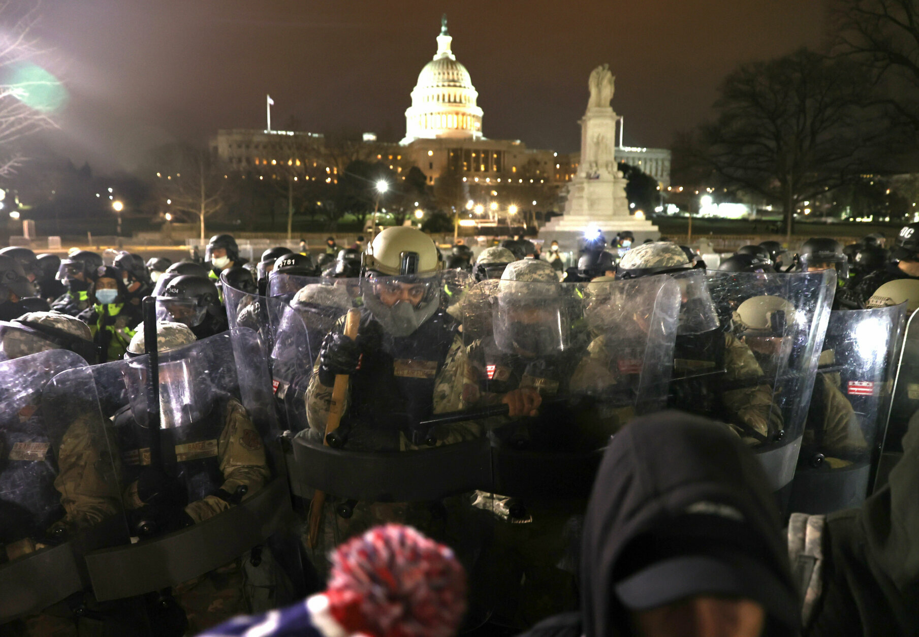 WASHINGTON, DC - JANUARY 06: Members of the National Guard assist police officers in dispersing protesters who are gathering at the U.S. Capitol Building on January 06, 2021 in Washington, DC. Pro-Trump protesters entered the U.S. Capitol building after mass demonstrations in the nation's capital during a joint session Congress to ratify President-elect Joe Biden's 306-232 Electoral College win over President Donald Trump. (Photo by Tasos Katopodis/Getty Images)