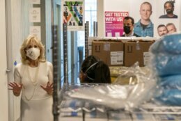 Beyond rows of personal protective medical equipment, first lady Jill Biden, left, speaks with Naseema Shafi, CEO of Whitman-Walker Health, during a tour of Whitman-Walker Health, Friday, Jan. 22, 2021, in Washington. (AP Photo/Jacquelyn Martin, Pool)