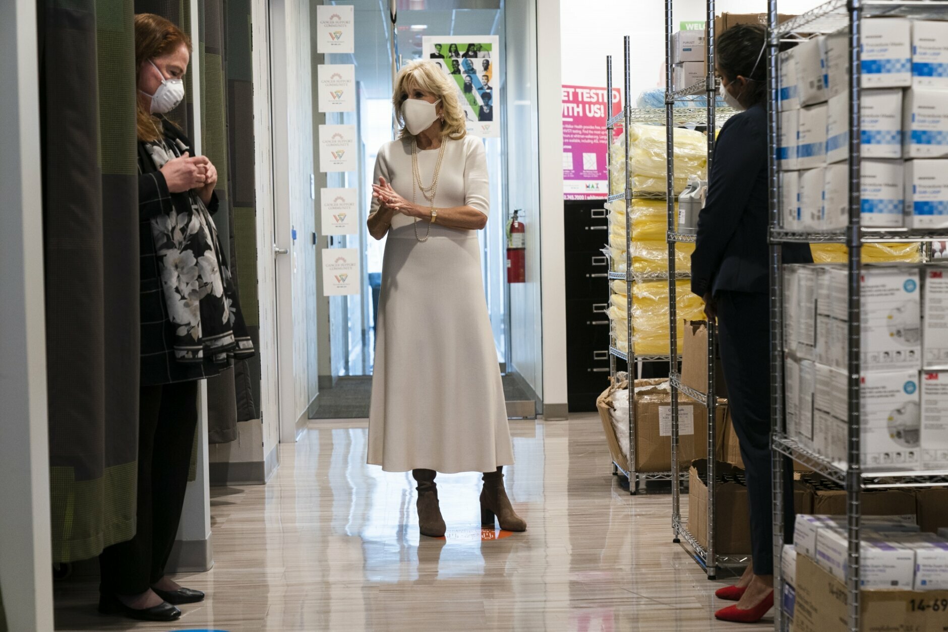 First lady Jill Biden, center, speaks with Kim Thiboldeaux, left, CEO of the Cancer Support Community, and Naseema Shafi, right, CEO of Whitman-Walker Health, during a tour of Whitman-Walker Health Friday, Jan. 22, 2021, in Washington. (AP Photo/Jacquelyn Martin, Pool)