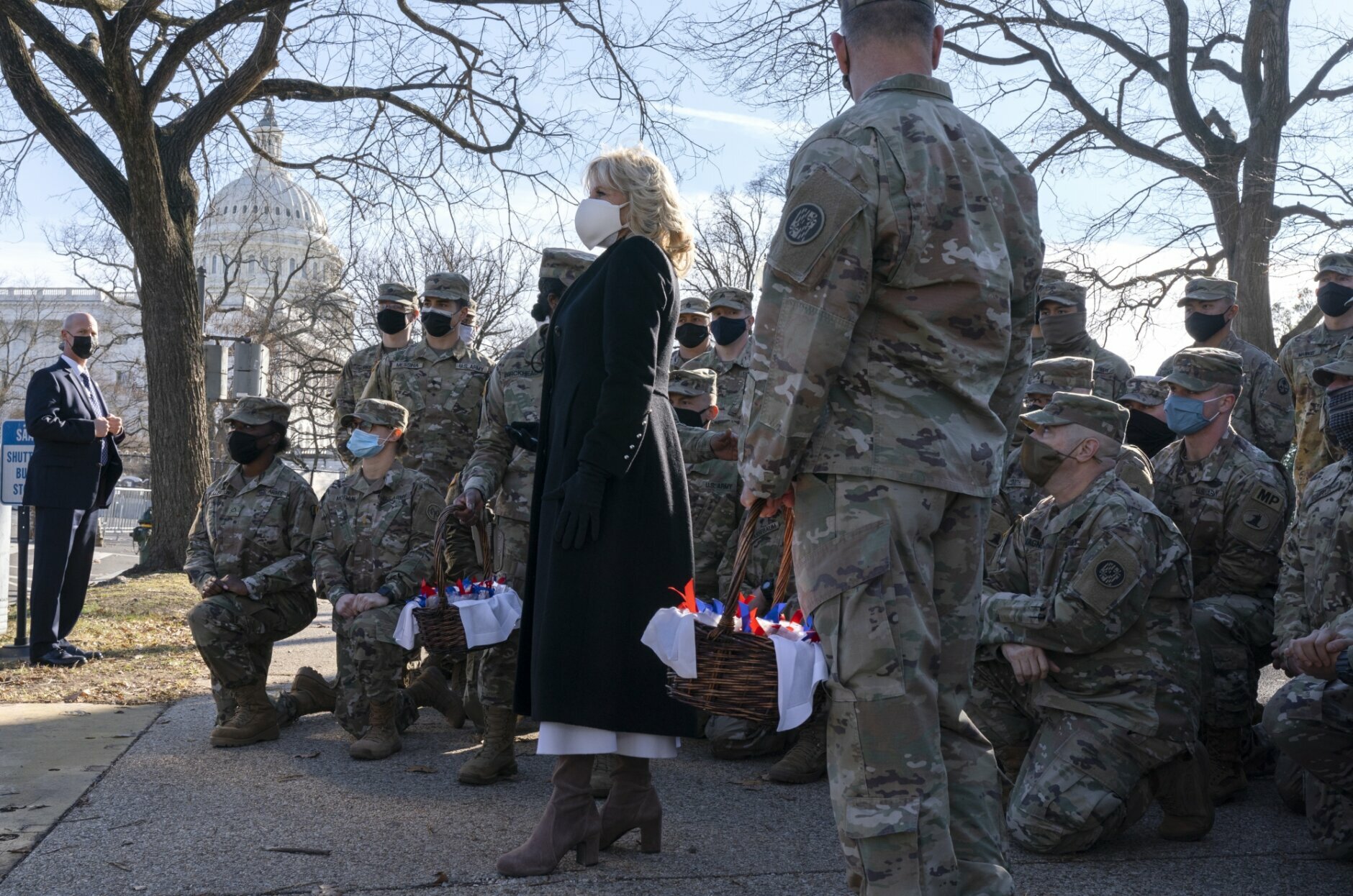 First lady Jill Biden poses for a photograph with members of the National Guard, after surprising them with chocolate chip cookies, Friday, Jan. 22, 2021, at the U.S. Capitol in Washington. (AP Photo/Jacquelyn Martin, Pool)