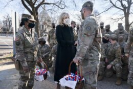 Saying, "The Biden's are a National Guard family," first lady Jill Biden greets members of the National Guard with chocolate chip cookies, Friday, Jan. 22, 2021, at the U.S. Capitol in Washington. (AP Photo/Jacquelyn Martin, Pool)