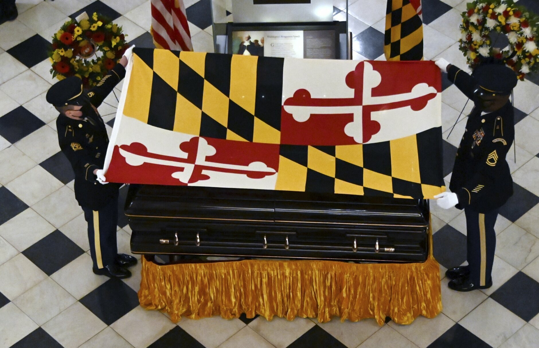 The Maryland National Guard Honor Guard drapes the Maryland flag on the casket of Maryland Senate President Emeritus Thomas V. Mike Miller under the dome of the State House in Annapolis, Md., Thursday, Jan. 21, 2021. (Kim Hairston/The Baltimore Sun via AP, Pool)