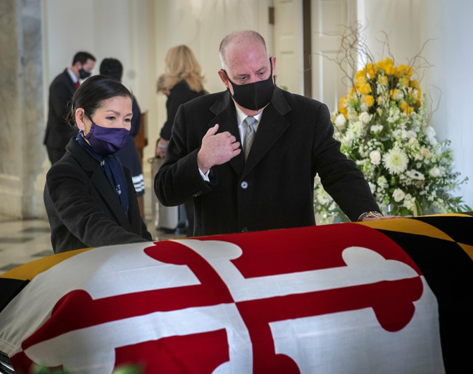 Gov. Larry Hogan, center, with wife Yumi, left, pays respects to the late Senate President Emeritus Thomas V. Mike Miller, Jr., under the dome of the statehouse at the Maryland Statehouse in Annapolis, Md., on Friday, Jan. 22, 2021.  Miller was a state legislator for 50 years. A Democrat, he served as president of the Maryland Senate for 33 years. He announced he was stepping down from the post in 2019, but he remained a senator until December. (Bill O'Leary/The Washington Post via AP, Pool)