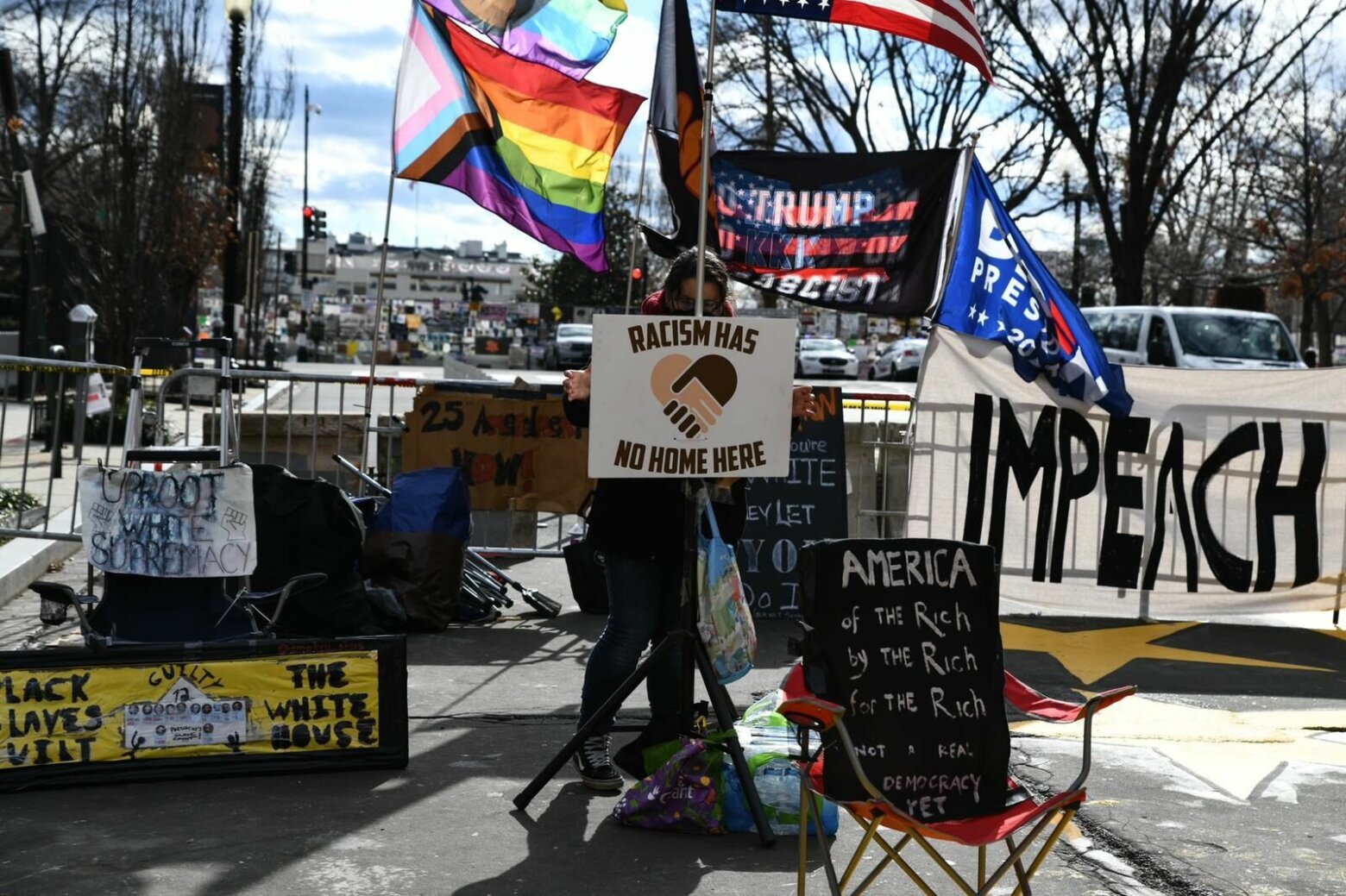 <p>Signs condemning President Trump sit in Black Lives Matter Plaza.</p>
