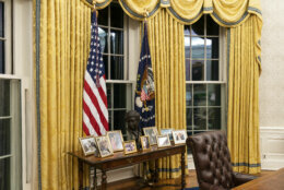 The Oval Office of the White House is newly redecorated for the first day of President Joe Biden's administration, Wednesday, Jan. 20, 2021, in Washington, including a table with family photos. (AP Photo/Alex Brandon)