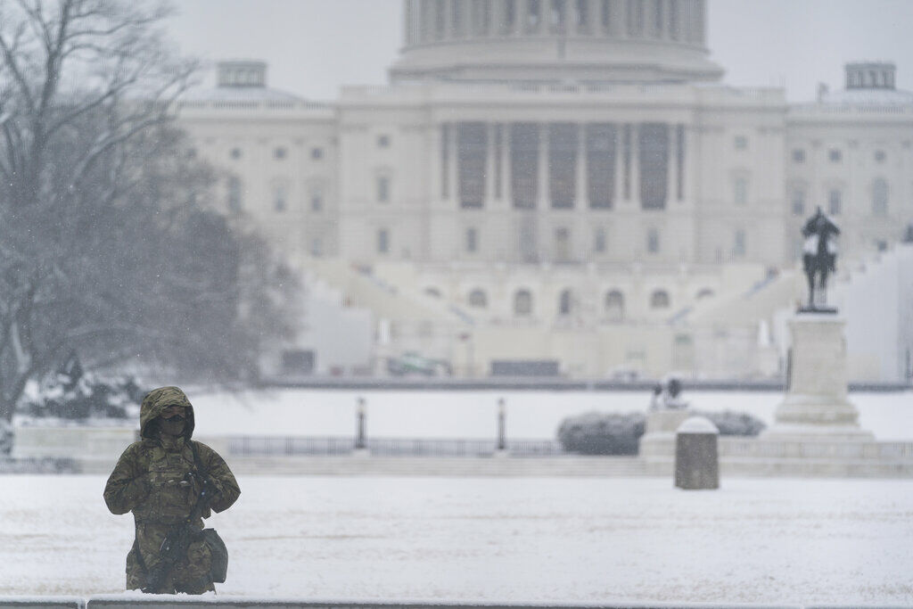 A National Guard soldier stands a post as snow falls in front of the U.S Capitol, Sunday, Jan. 31, 2021, in Washington. (AP Photo/Alex Brandon)