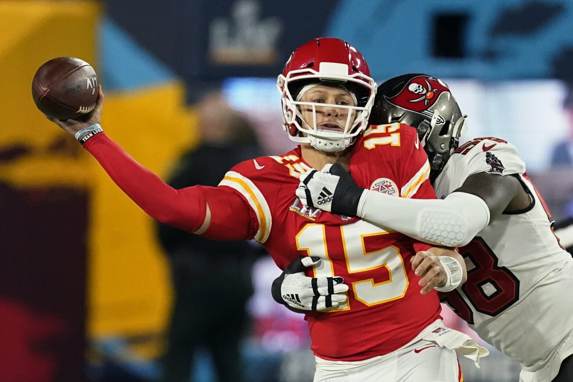 Kansas City Chiefs quarterback Patrick Mahomes passes under pressure from Tampa Bay Buccaneers outside linebacker Shaquil Barrett during the first half of the NFL Super Bowl 55 football game Sunday, Feb. 7, 2021, in Tampa, Fla. (AP Photo/Ashley Landis)
