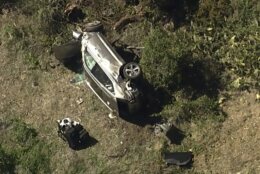 In this aerial image take from video provided by KABC-TV, a vehicle rest on its side after a rollover accident involving golfer Tiger Woods along a road in the Rancho Palos Verdes suburb of Los Angeles on Tuesday, Feb. 23, 2021. Woods had to be extricated from the vehicle with the "jaws of life" tools, the Los Angeles County Sheriff's Department said in a statement. Woods was taken to the hospital with unspecified injuries. The vehicle sustained major damage, the sheriff's department said. (KABC-TV via AP)
