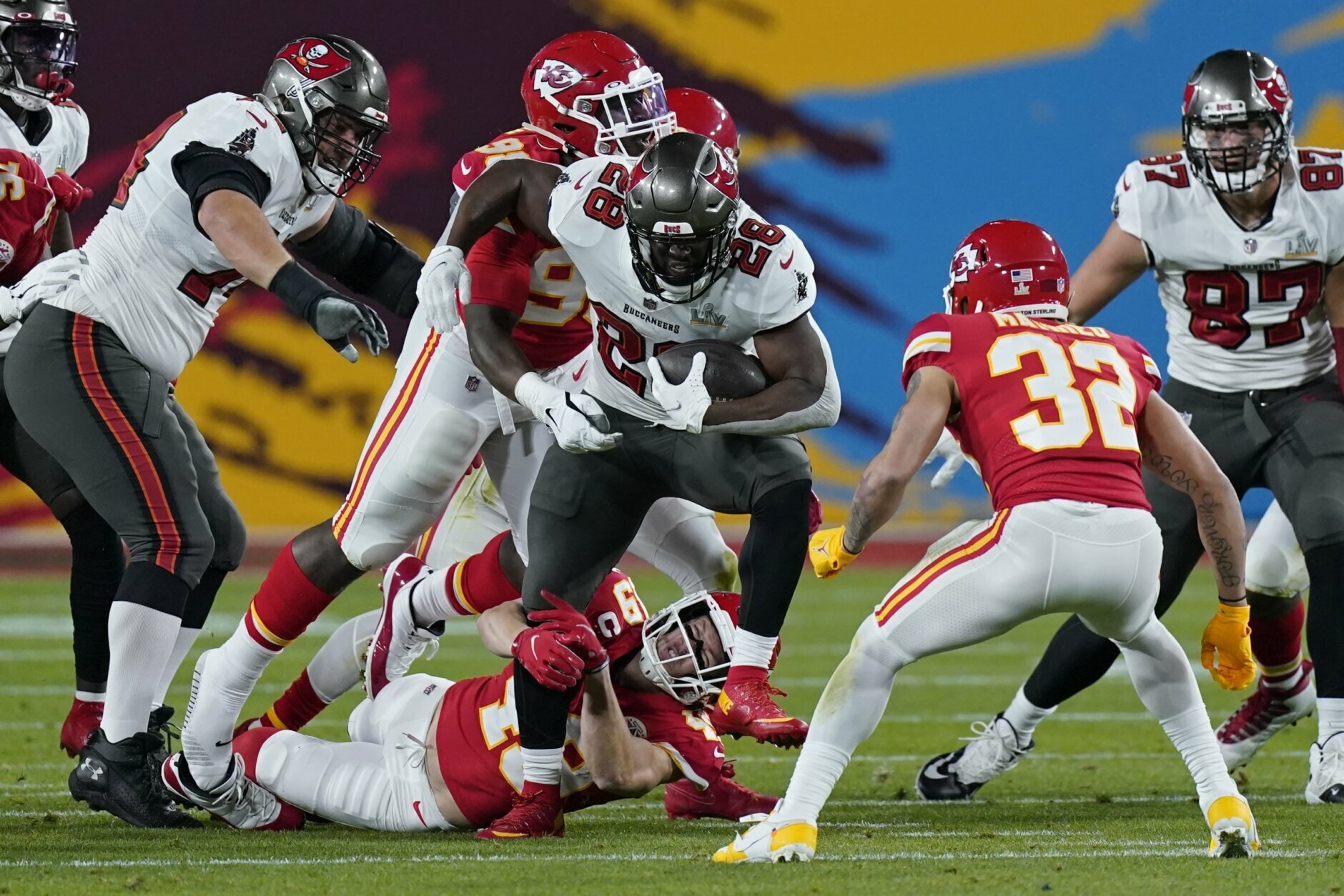 Kansas City Chiefs free safety Daniel Sorensen grabs the leg of Tampa Bay Buccaneers running back Leonard Fournette during the first half of the NFL Super Bowl 55 football game Sunday, Feb. 7, 2021, in Tampa, Fla. (AP Photo/Mark Humphrey)