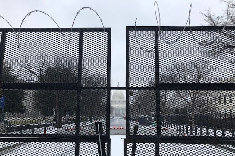 The U.S. Capitol behind fences.