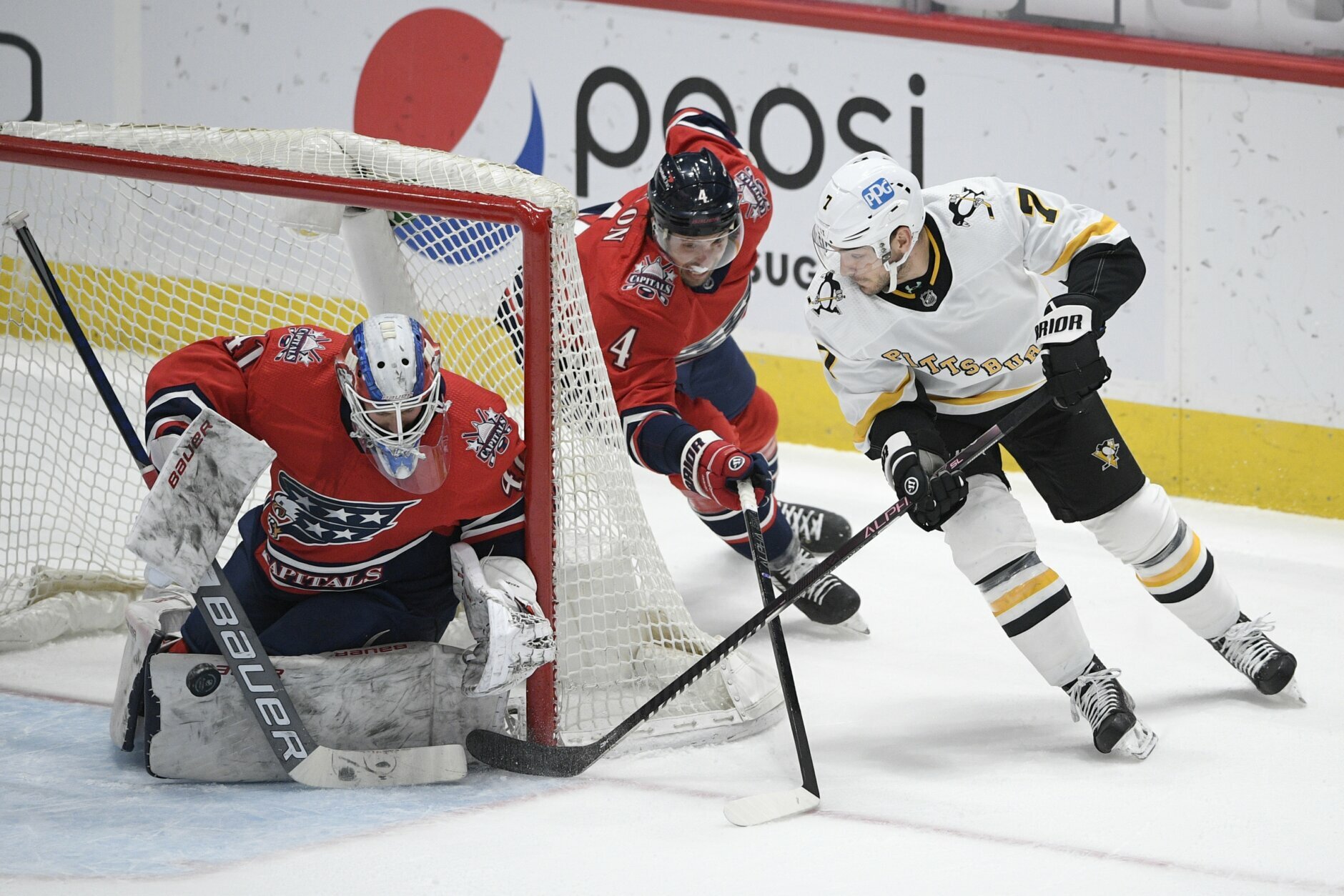 Washington Capitals goaltender Vitek Vanecek (41) stops the puck against Pittsburgh Penguins center Colton Sceviour (7) during the first period of an NHL hockey game, Tuesday, Feb. 23, 2021, in Washington. Also seen is Capitals defenseman Brenden Dillon (4). (AP Photo/Nick Wass)