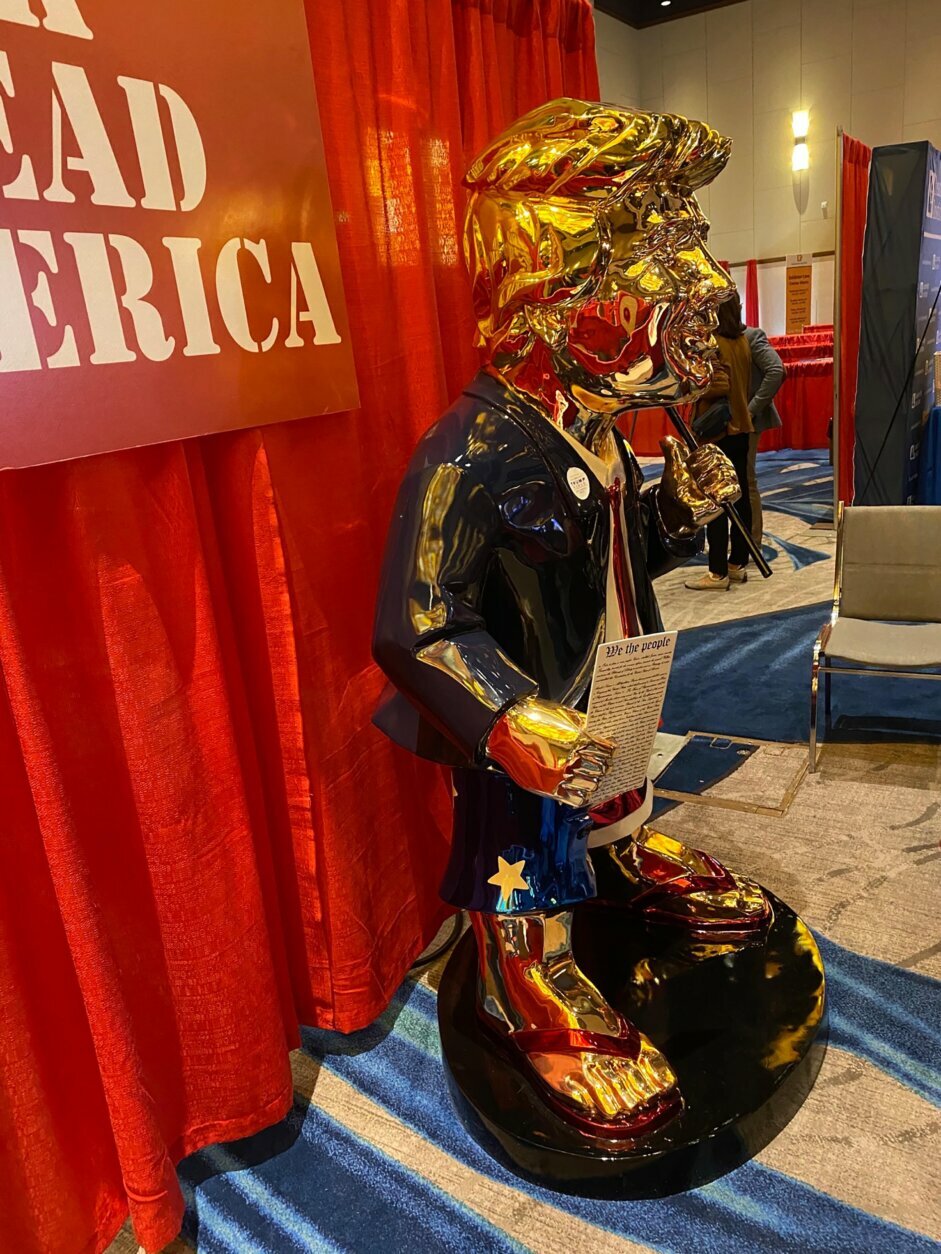 A golden Trump statue is displayed at the 2021 Conservative Political Action Conference.