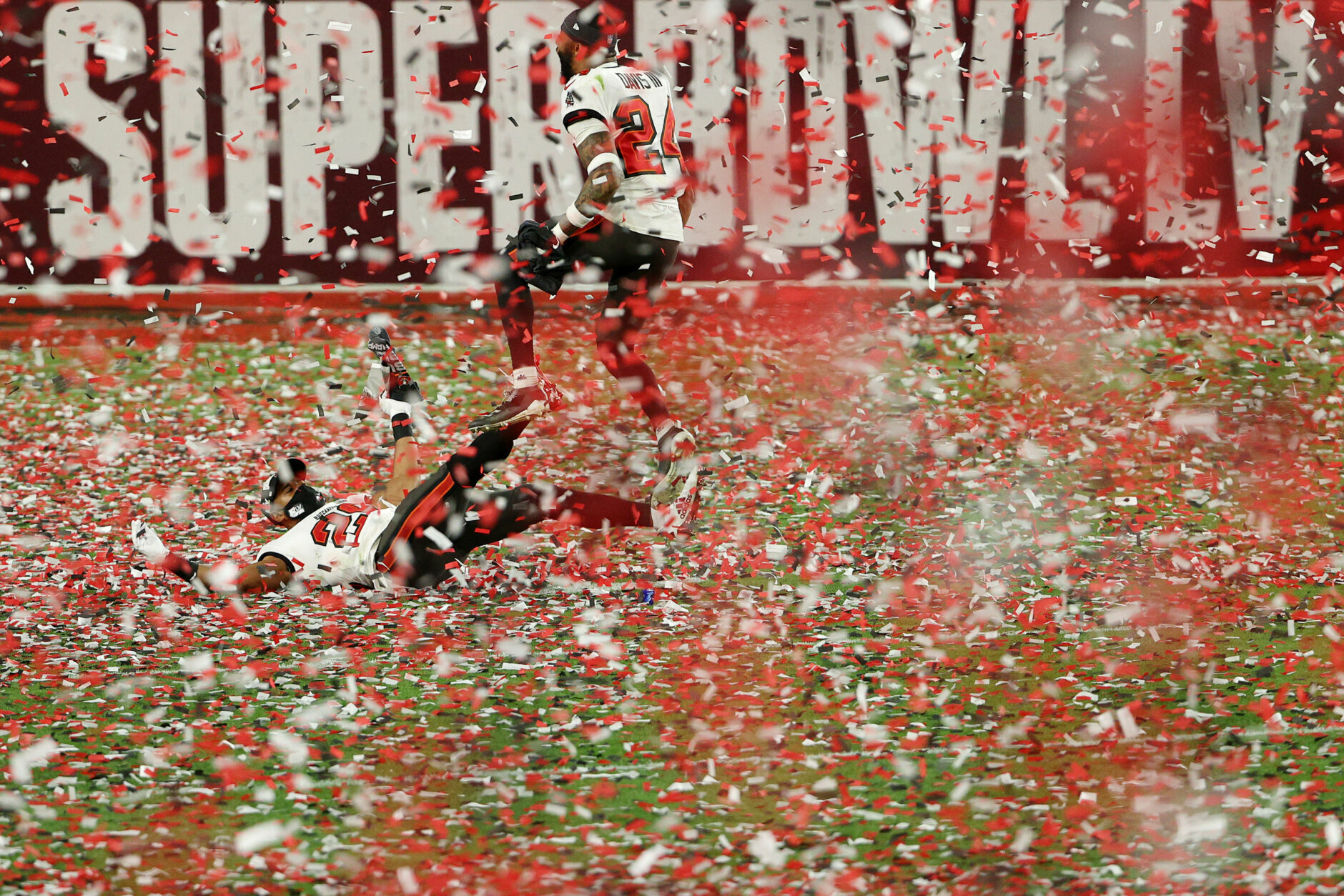 TAMPA, FLORIDA - FEBRUARY 07: Andrew Adams #26 and Carlton Davis #24 of the Tampa Bay Buccaneers celebrate as confetti falls after defeating the Kansas City Chiefs  in Super Bowl LV at Raymond James Stadium on February 07, 2021 in Tampa, Florida. The Buccaneers defeated the Chiefs 31-9. (Photo by Patrick Smith/Getty Images)