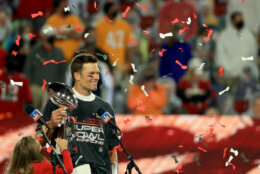 TAMPA, FLORIDA - FEBRUARY 07: Tom Brady #12 of the Tampa Bay Buccaneers hoists the Vince Lombardi Trophy after winning Super Bowl LV at Raymond James Stadium on February 07, 2021 in Tampa, Florida. The Buccaneers defeated the Chiefs 31-9. (Photo by Mike Ehrmann/Getty Images)