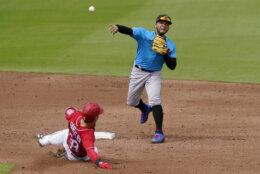 Washington Nationals' Tres Barrera (38) is out at second as Miami Marlins second baseman Isan Diaz throws to first for a double play during the third inning of a spring training baseball game, Wednesday, March 3, 2021, in West Palm Beach, Fla. (AP Photo/Lynne Sladky)