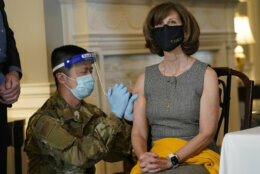 Virginia First Lady Pam Northam receives a COVID-19 vaccination from Tech Sgt. Hsuan Kuo, of the Virginia Air National Guard at the Governors Mansion in Richmond, Va., Monday, March 15, 2021.   The Northam’s got a shot of the Johnson &amp; Johnson coronavirus vaccine, joining the growing number of Virginians who are being inoculated against the potentially deadly disease.   (AP Photo/Steve Helber)