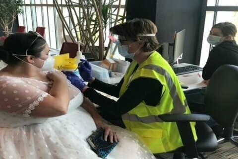 Bride wears wedding dress to get vaccine