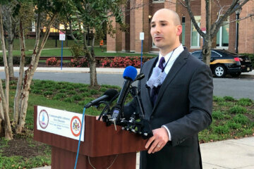 official speaks at podium
