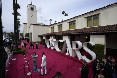 AP PHOTOS: Faces new and familiar at a most unusual Oscars
