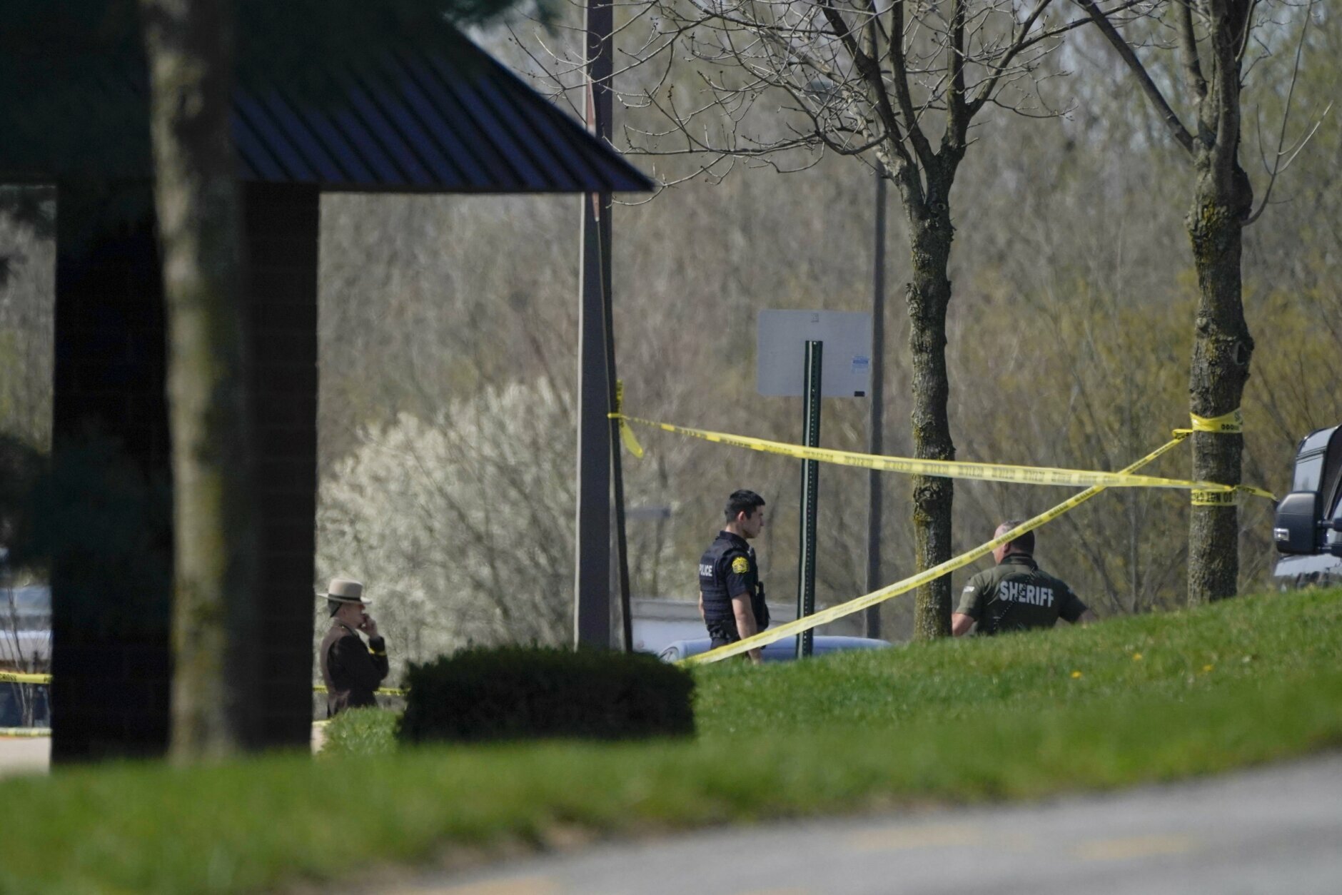 Police stand around an area cordoned off by police tape on Progress Court, near the scene of a shooting at a business park, in Frederick, Md., Tuesday, April 6, 2021. (AP Photo/Julio Cortez)