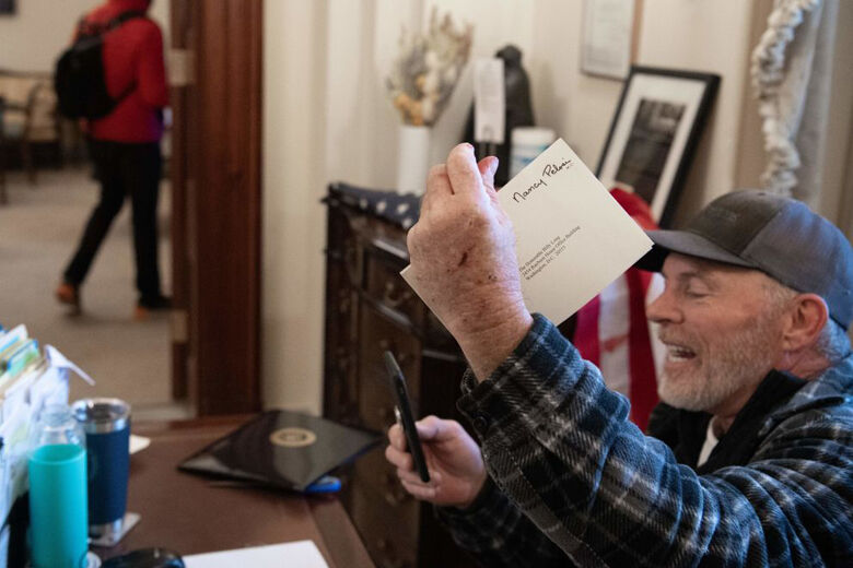 <p>Richard Barnett, a supporter of former President Donald Trump sits inside the office of Speaker of the House Nancy Pelosi inside the U.S. Capitol in Washington, D.C., Jan. 6, 2021. — Demonstrators breeched security and entered the Capitol as Congress debated the a 2020 presidential election Electoral Vote Certification.</p>
