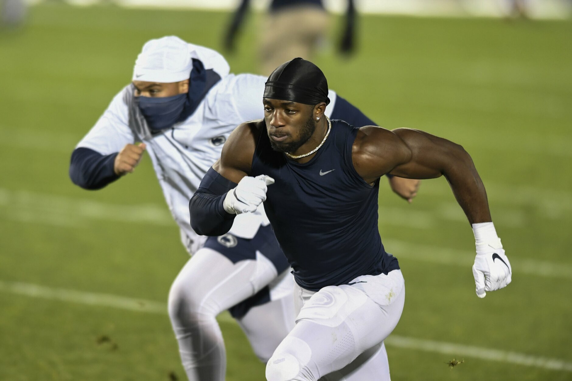 FILE - Penn State defensive end Jayson Oweh warms up before an NCAA college football game against Ohio State in State College, Pa., in this Saturday, Oct. 31, 2020, file photo. Oweh is a possible first round pick in the NFL Draft, April 29-May 1, 2021, in Cleveland. (AP Photo/Barry Reeger, File)
