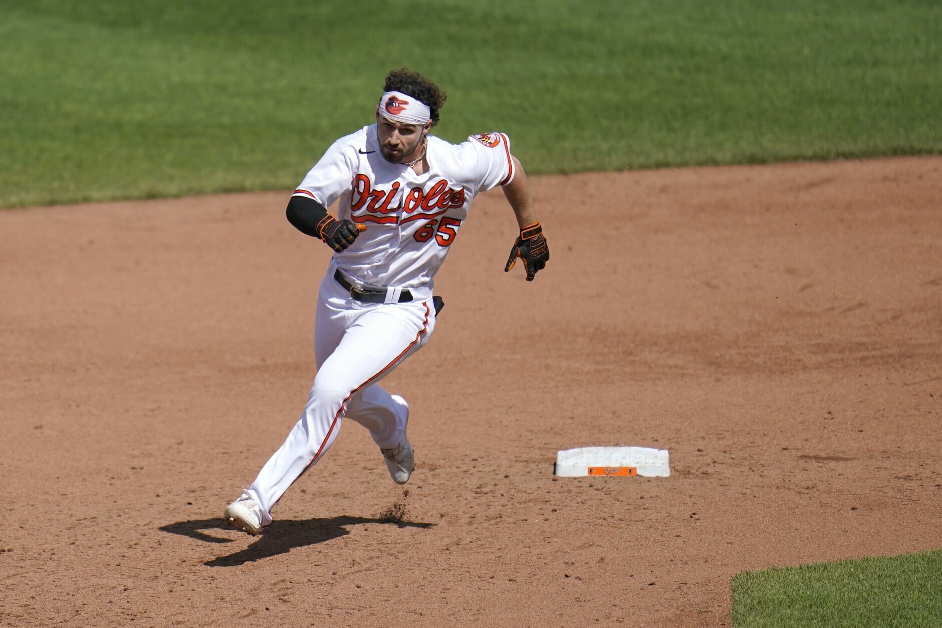 Baltimore Orioles' Ryan McKenna runs past second base while hitting a triple against the Boston Red Sox during the sixth inning of a baseball game, Sunday, April 11, 2021, in Baltimore. (AP Photo/Julio Cortez)