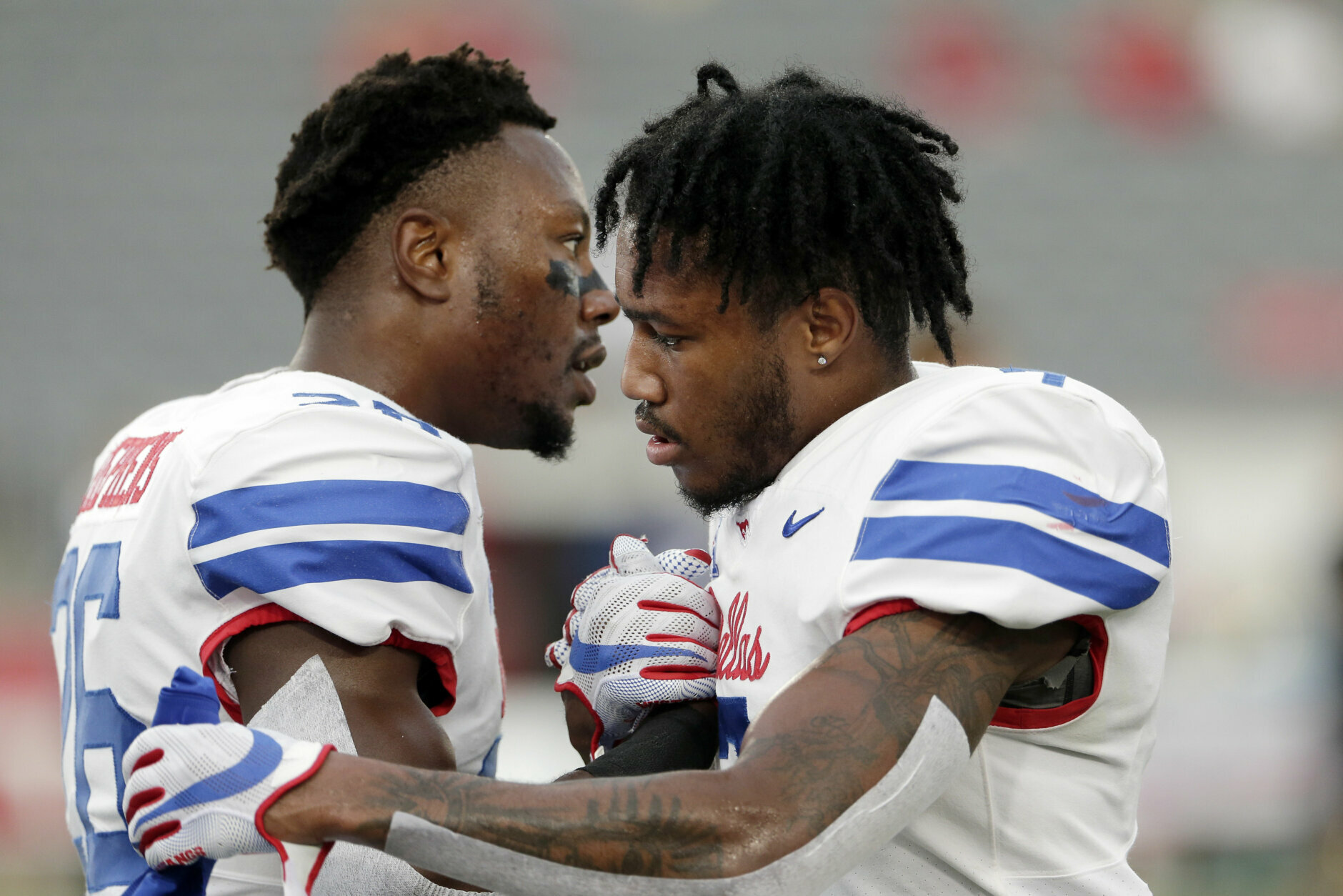 SMU defensive back Brandon Stephens, left, and SMU cornerback Robert Hayes Jr., right, shake hands before an NCAA college football game Thursday, Oct. 24, 2019, in Houston. (AP Photo/Michael Wyke)