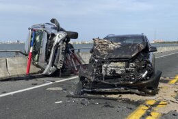 This photo provided by the Ocean City Fire Department shows the wreckage from a car accident on the Route 90 bridge in Ocean City, Md., on Sunday, May 2, 2021. A bystander jumped over a highway guard rail and into a Maryland bay Sunday to rescue a child who had been thrown from a car and into the water during the crash, according to authorities. The child was ejected from a car on the Route 90 bridge in Ocean City and landed in the Assawoman Bay, the Ocean City Fire Department said in a statement. At least eight people were injured in total, the agency said. (Ocean City Fire Department via AP)