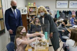 President Joe Biden and first lady Jill Biden, watch a student demonstrate her project, during a visit to Yorktown Elementary School, Monday, May 3, 2021, in Yorktown, Va. (AP Photo/Evan Vucci)