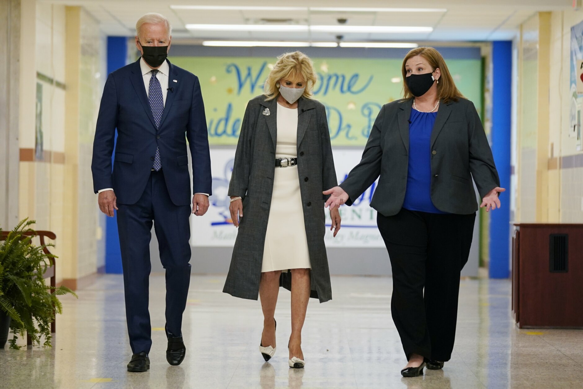 President Joe Biden and first lady Jill Biden, walk with Principal Kelly Denny, during a visit to Yorktown Elementary School, Monday, May 3, 2021, in Yorktown, Va. (AP Photo/Evan Vucci)