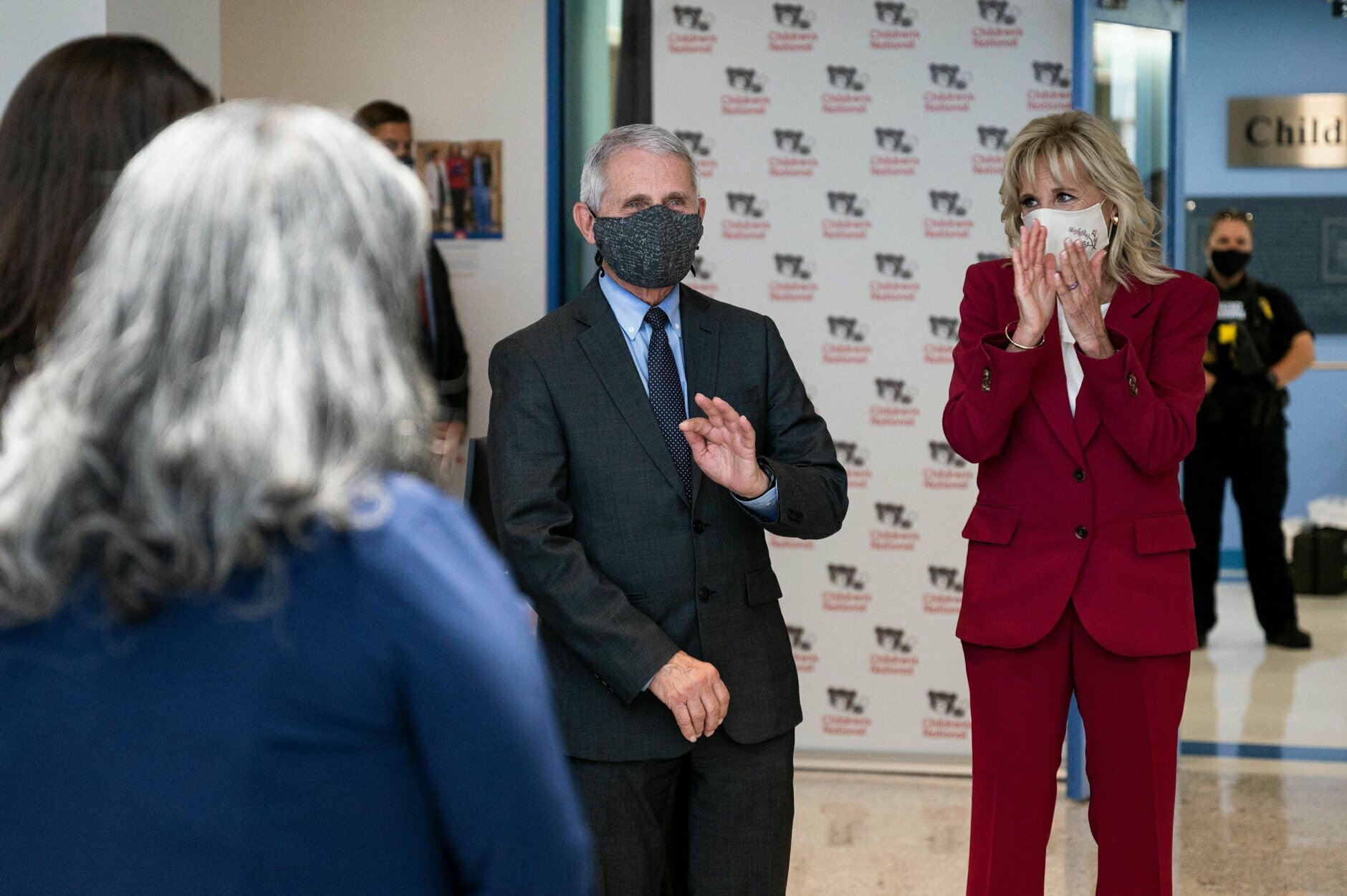 Dr. Anthony Fauci (C) waves as US First Lady Jill Biden (R) introduces him as an American Hero as they tour the vaccination center at the Children's National Hospital in Washington, DC on May 20, 2021. (Photo by JIM WATSON / AFP) (Photo by JIM WATSON/AFP via Getty Images)