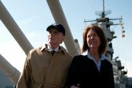 NORFOLK, VA - MARCH 15: Former U.S. Sen. John Warner and his wife, Jeanne, tour the Hampton Roads Naval Museum and the Battleship Wisconsin on March 15, 2013 in Norforlk, Virginia. Warner is attending the keel laying ceremony for the Virginia-class attack submarine Pre-Commissioning Unit (PCU) John Warner (SSN 785). Warner has served as an undersecretary of the Navy, a U.S. senator, a Marine Corps officer during the Korean War and  as a Navy petty officer in World War II. PCU John Warner is under construction at Newport News Shipbuilding. (Photo by Specialist 2nd Class Daniel Meshel/U.S. Navy via Getty Images)