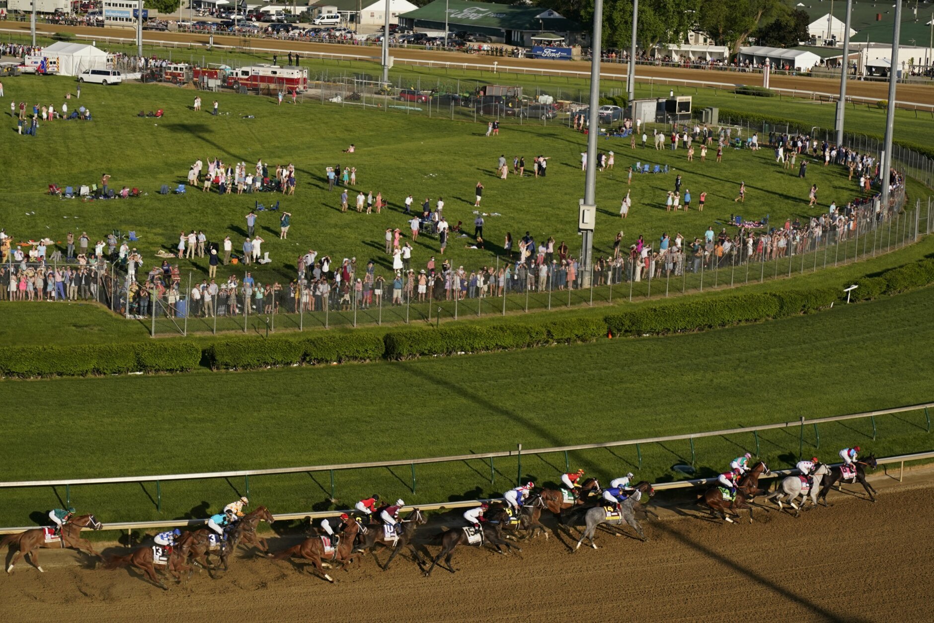 Medina Spirit, right, with John Velazquez aboard, leads the field around the first turn on the way to winning the 147th running of the Kentucky Derby at Churchill Downs, Saturday, May 1, 2021, in Louisville, Ky. (AP Photo/Charlie Riedel)