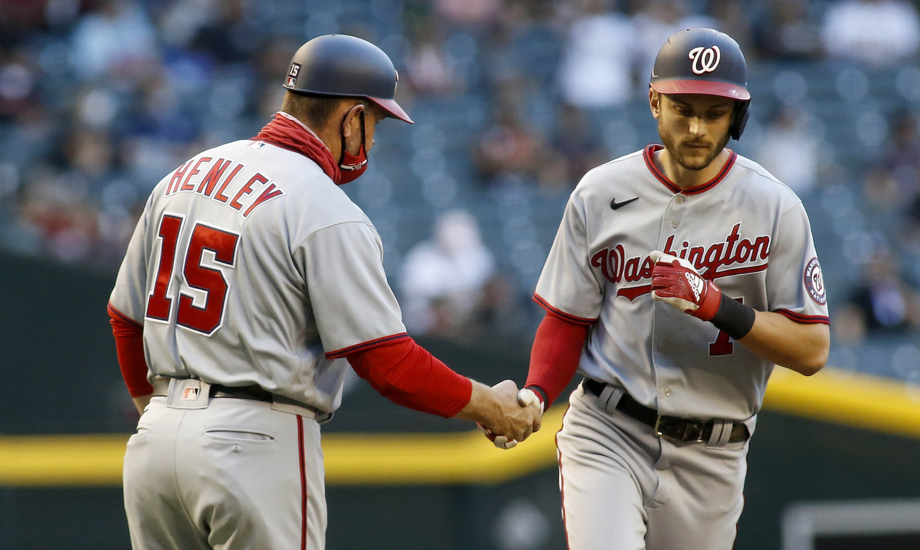 Washington Nationals' Yan Gomes, left, runs to home plate after passing  third base coach Bob Henley during a solo home run to left center field in  the seventh inning of a baseball