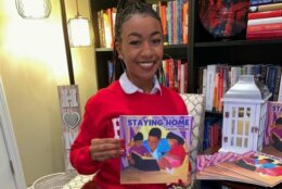 <p>Kendall Robinson and the book she illustrated &#8220;Staying Home&#8221; by Carolyn Woods. (Courtesy Kendall Robinson)</p>
